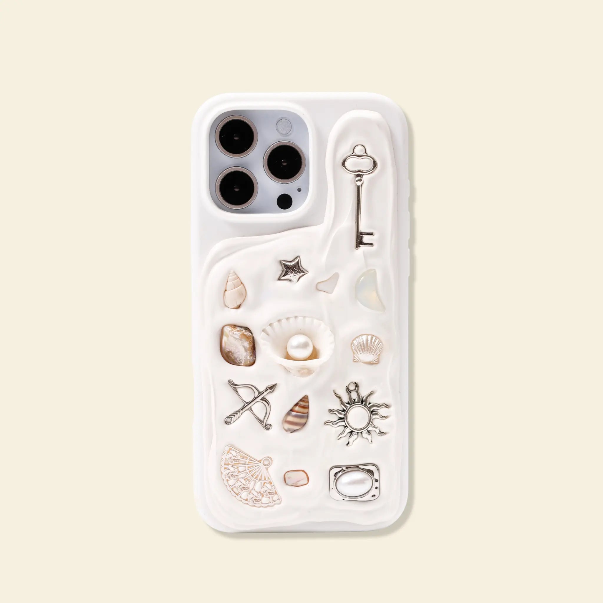 Personalised charm phone case with evil eye, sun, key and cupid charms from The Charmé Edit