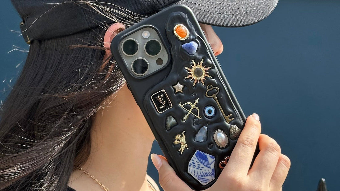 Personalised charm phone case with sun, key, and evil eye charms from The Charmé Edit