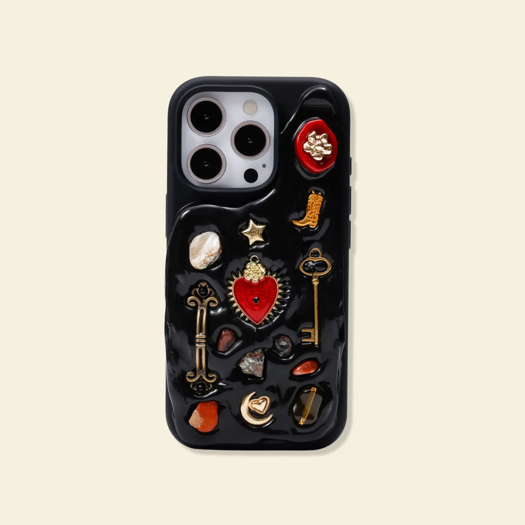 Phone case with decorative pins on a beige background