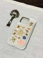 custom aesthetic phone case with soft colours and small charms, unique handmade design