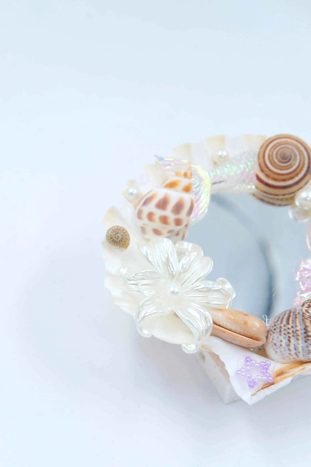 handmade home decor: seashell mirror aesthetic with natural spiral shells.
