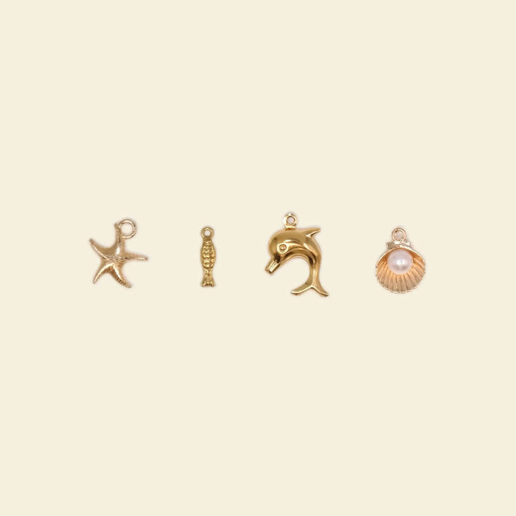 gold phone charms: starfish, dolphin, and seashell charms for custom phone cases.