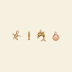 gold phone charms: starfish, dolphin, and seashell charms for custom phone cases.