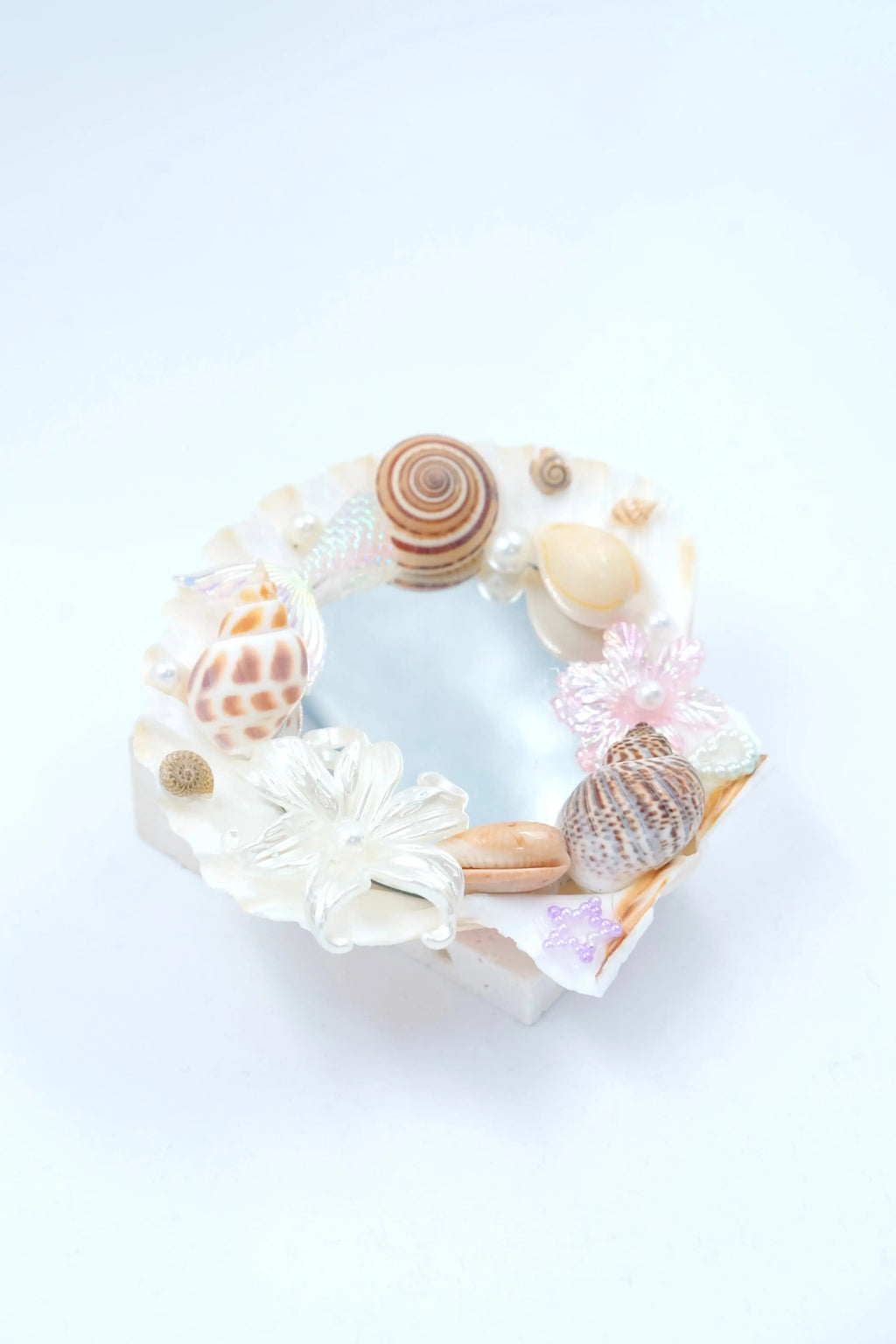 handmade home decor: seashell mirror aesthetic with natural spiral shells.