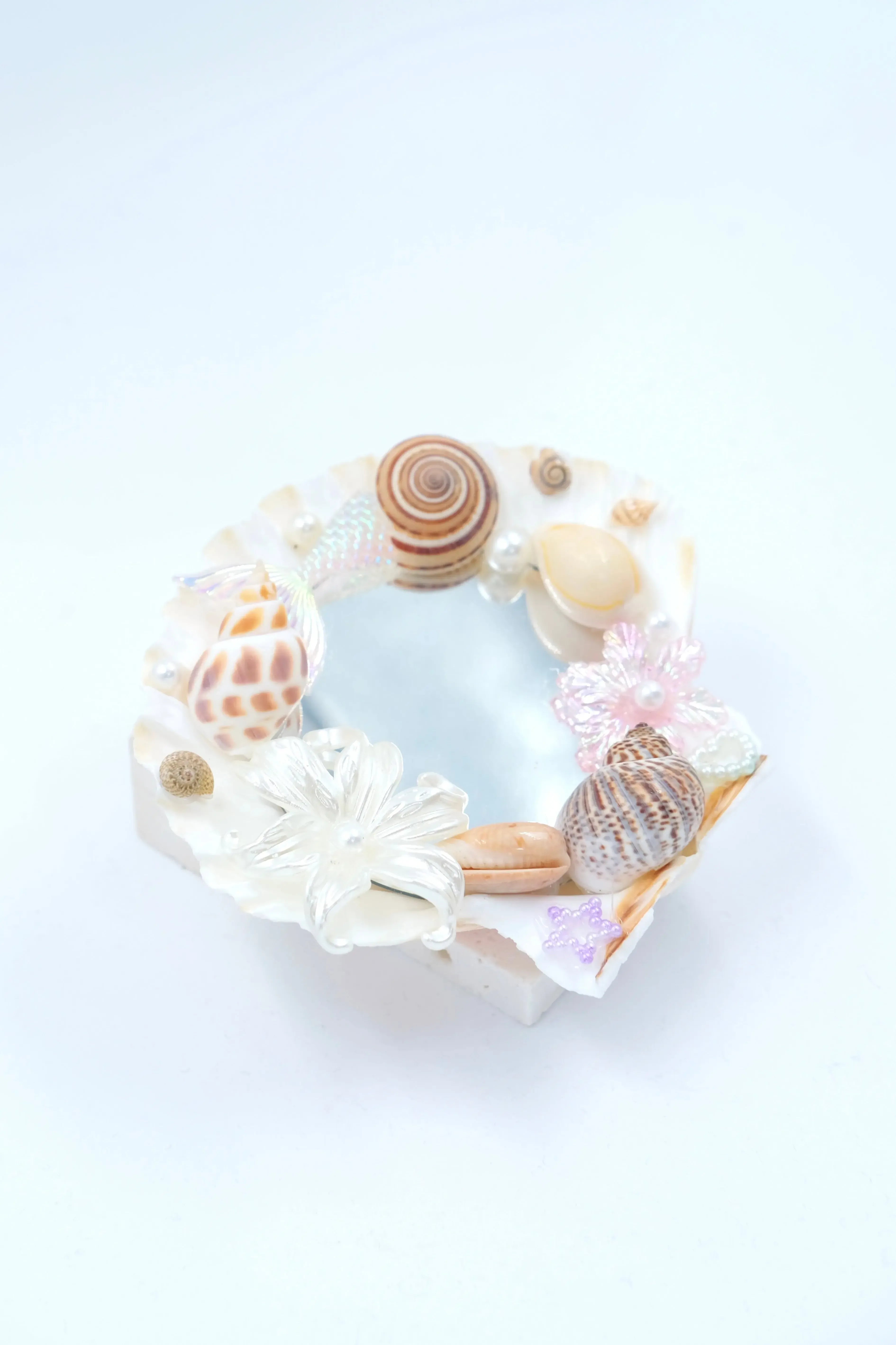 handmade home decor: seashell mirror aesthetic with natural spiral shells.