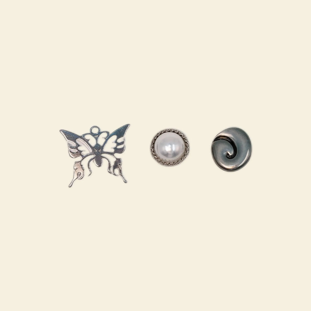 silver phone charms: butterfly and pearl custom phone case accessories.