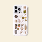 Phone case with decorative pins on a beige background