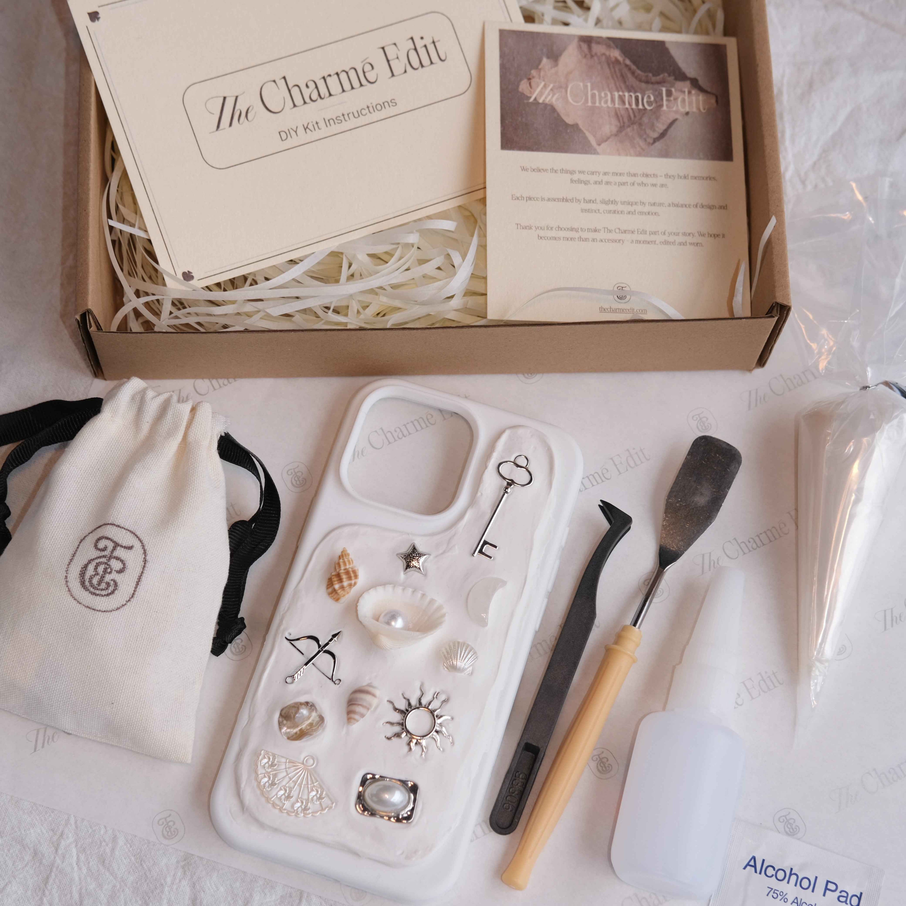 The Charme Edit DIY phone case kit with charms, seashells, tools, and materials to create a custom handmade iPhone case. Perfect for birthdays, creative gifts, craft parties, or a relaxing self-care project.