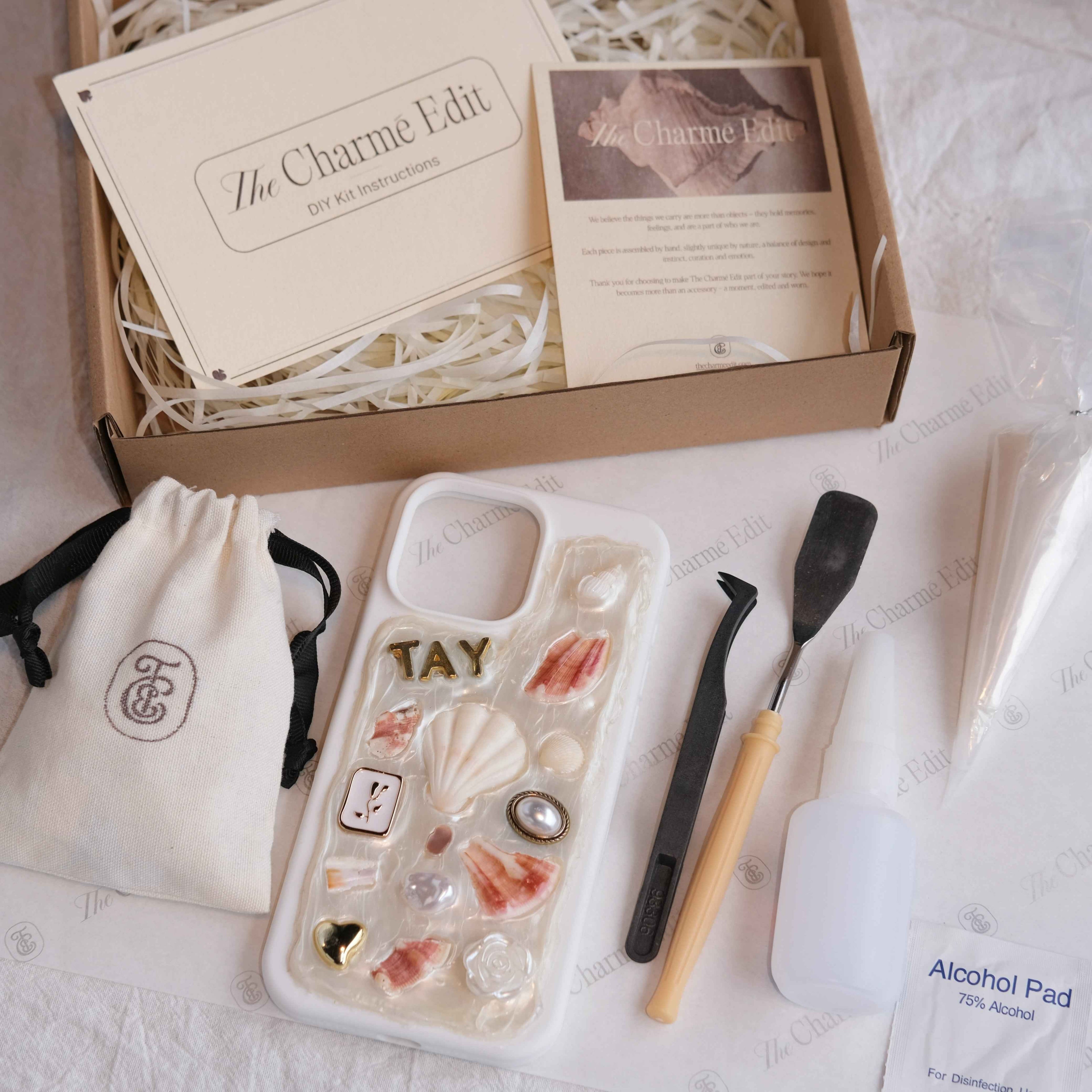 The Charme Edit DIY phone case kit with charms, seashells, tools, and materials to create a handmade custom iPhone case. Perfect for birthdays, creative gifts, craft parties, or a relaxing self-care project. | Craft ideas, custom phone cases, DIY phone cases