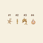 gold phone charms: starfish, dolphin, and seashell charms for personalised phone cases.
