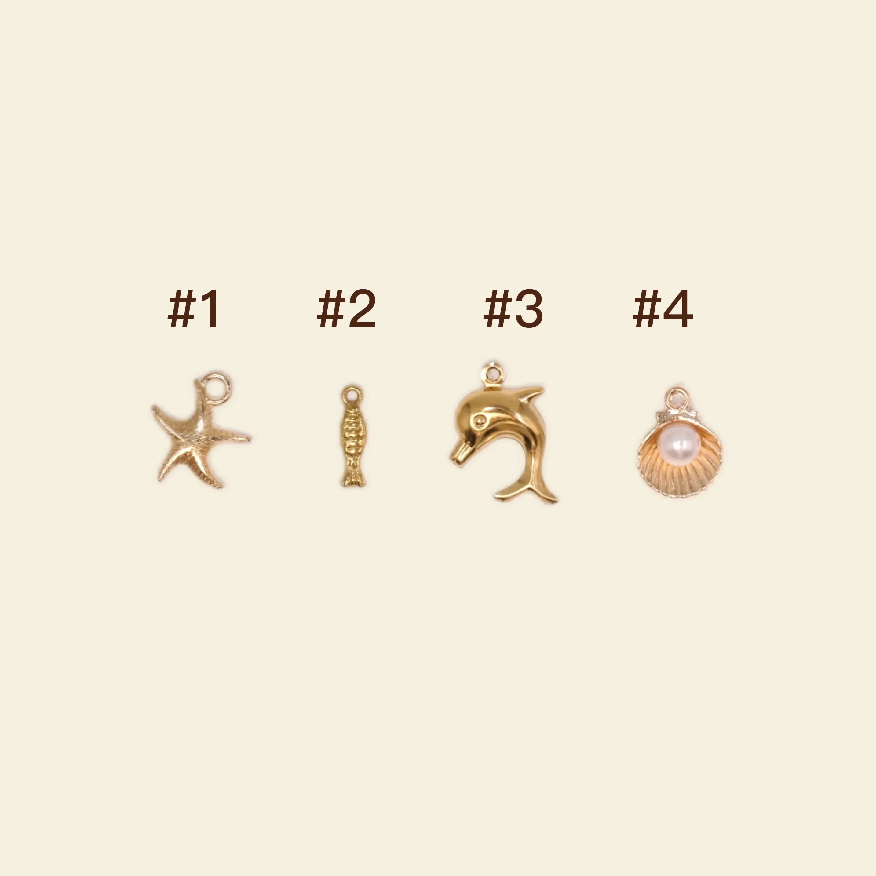 gold phone charms: starfish, dolphin, and seashell charms for personalised phone cases.