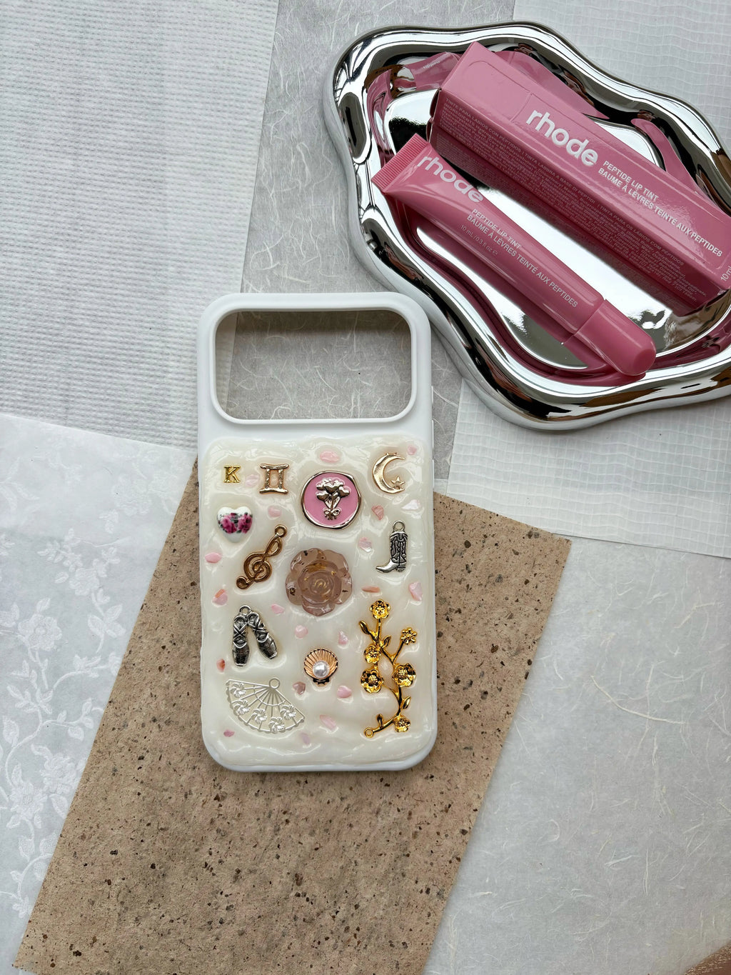 girly aesthetic phone case with charms styled with makeup, handmade custom phone accessory