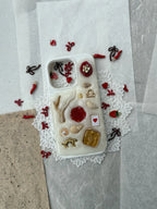 coquette style phone case with red bow and strawberry charms, handmade custom phone case