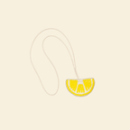 The Amalfi Lemon hand-beaded lemon slice bag charm