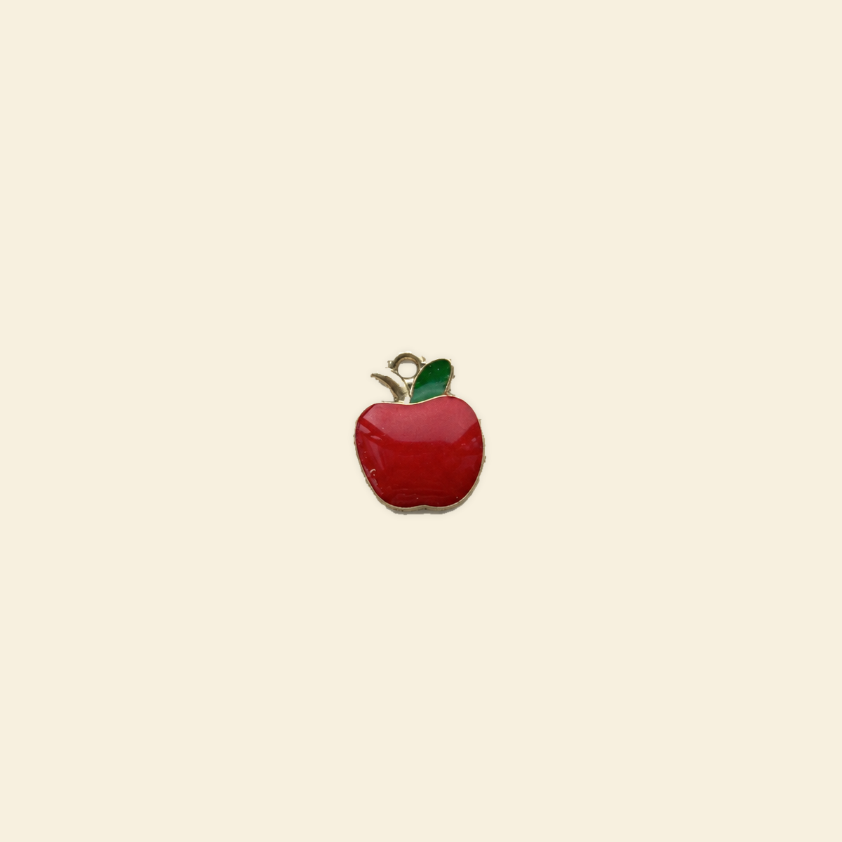 apple charm on a solid #f7f0df background