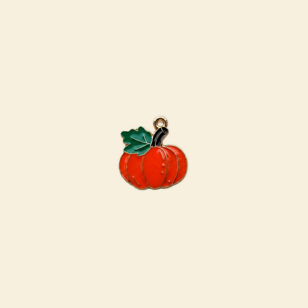 pumpkin charm on a solid #f7f0df background