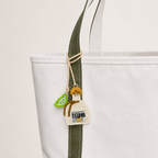 The Tequila and Lime Pair hand-beaded bag charm tied to a white tote
