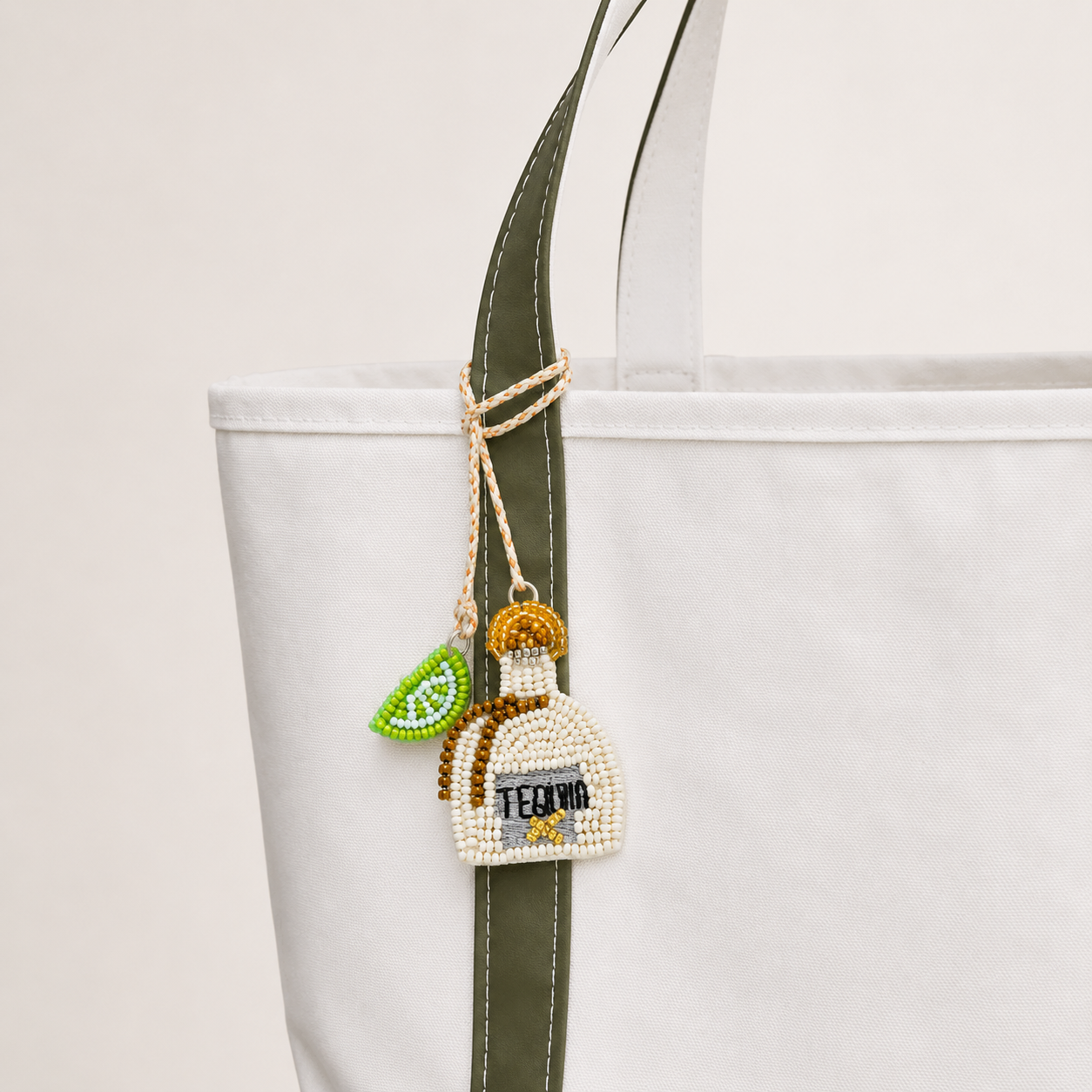 The Tequila and Lime Pair hand-beaded bag charm tied to a white tote