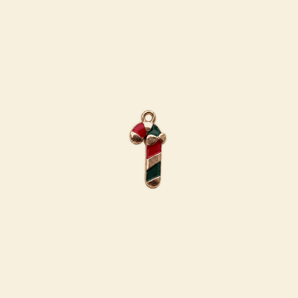 candy cane charm on a solid #f7f0df background