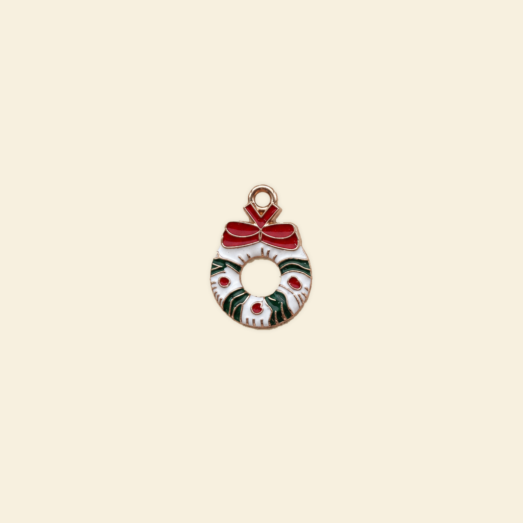 wreath charm on a solid #f7f0df background